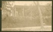 Edwin Markham on porch of house