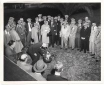 Early Birds of Aviation group, standing in front of a palm tree and laying a wreath