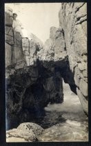 Rock arch over white water