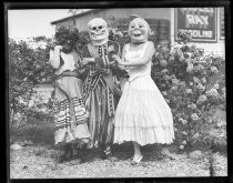 Three people in costume for Fiesta