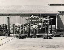 "Mr. Leonard and Mr. Amori in front of Amori's invention"