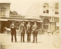 Four men in front of Leddy's Market