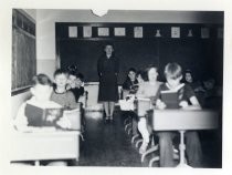 Ruby Levin posing in classroom with students