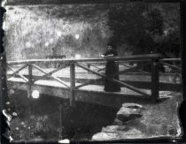 Woman on wooden bridge in the woods