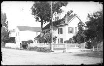 Colonial-style home with buggy parked on street