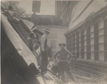 Men inside building with earthquake damage