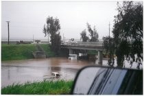 Flooded street with stranded trucks. Possibly the 1998 El Nino Flood in California