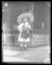 Child with Fiesta de las Rosas doll