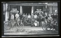 Men posing outside Maxwell Cyclery, Bisceglia Building