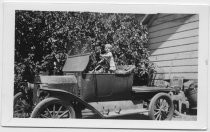 Bohnett toddler standing in driver's seat of pickup truck