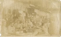 Women around fruit/nut packing table