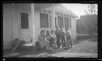 Family on steps of cabin