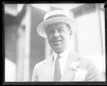 Outdoor portrait of man wearing straw boater and suit