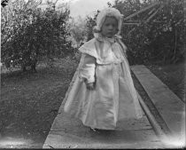 Toddler outside in bonnet and coat, c. 1912