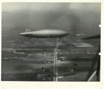 U.S. Navy airship over fields