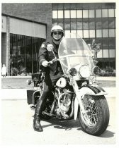 Police officer on motorcycle outside City Hall