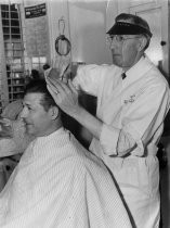 Bob Hamilton receiving a haircut