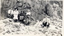 Harold Elliott and group seated on rocks