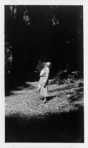 Mabel Elliott looking up at tall redwoods, Muir Woods