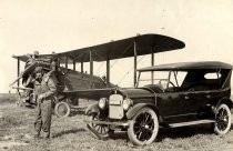 Eddie Rickenbacker with biplane and automobile