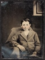 Portrait of child seated in chair