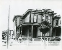 Two-story Victorian house, palm tree