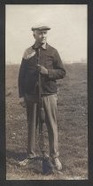 Man standing in field with rifle