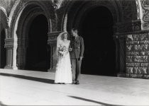 U.S. Army soldier and his bride standing in front of two ornate arches