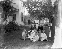 Multi-generational family portrait on lawn, c. 1912