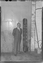 Unidentified man in suit with aerial bomb