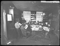 Group reading newspapers