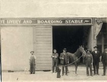 Men outside livery and boarding stable