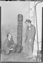 Unidentified men in suits, with aerial bomb