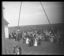 Large gathering near field, with American flags