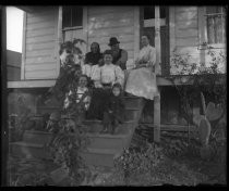 Family portrait with dog on steps of cabin, with cactus