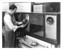 Man examining speakers of Ampex Crescendo Console unit