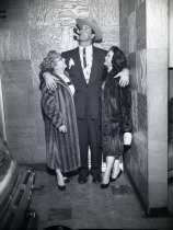 Ben Sharpe posing with two women in fur coats