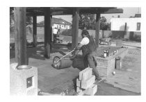 Rolling tiles in place underneath Pellier Park grape arbor