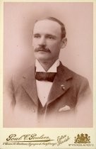 Portrait of man in suit with polka-dot bowtie