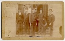 Group portrait of men on steps of First National Bank