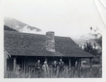 Ed and Ruby Levin in front of log cabin