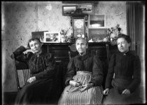 Three women seated in chairs, c. 1906