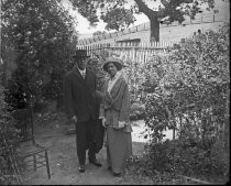 Man and woman posing in garden, c. 1912