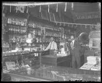 Two men inside pharmacy, c. 1905