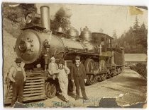 Group portrait in front of locomotive