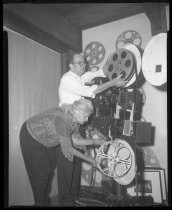 Willys and Betty Peck assembling their 35-mm film projector