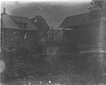 Buildings around a pond or river, c. 1912