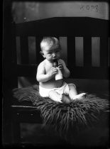 Portrait of baby in diaper with bottle