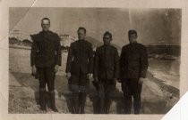 Four soldiers on resort beach