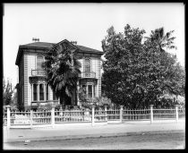 Two-story Italianate house with fence